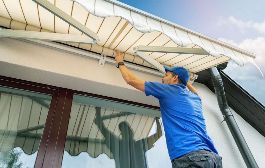 Image of a man installing a retractable awning.